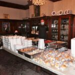 Freddie Faraone, Farone Catering standing in front of the ready to go meals in the museum dining room