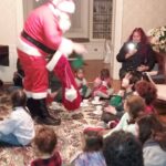 santa passing out treats to the children