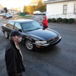 Tom Weller, LCHS Board Member and Kathi Wisniewski, LCHS Administrator taking tickets from cars and delivering food