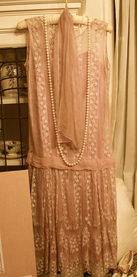 woman's dress with long strand of pearls