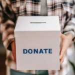 person holding a donation box