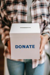 person holding a donation box