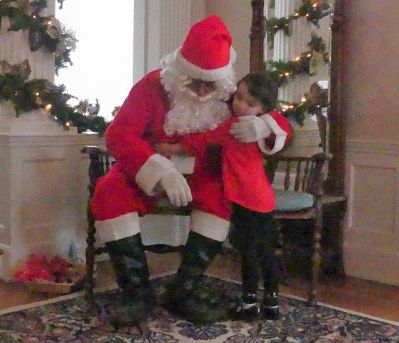 photo of little girl hugging santa