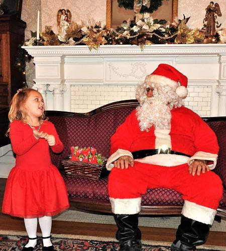 photo of young girl talking with santa claus