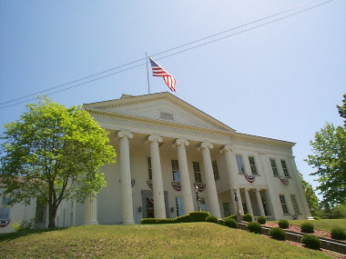 lawrence county courthouse with american flag flying from flagpole on the roof