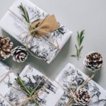 photo of snow on pine cones and winter gift wrapped packages