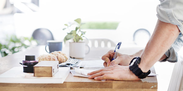 photo of man writing a document