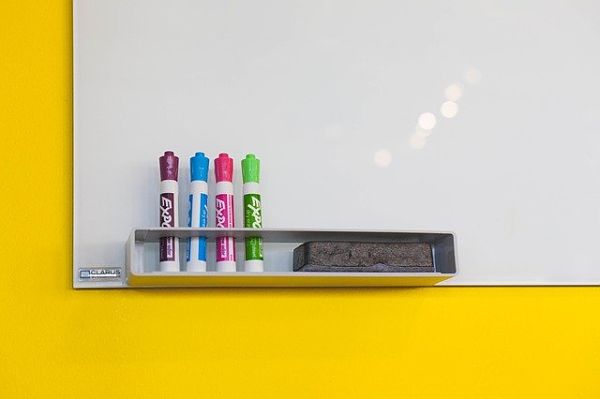 white board with colored markers and eraser